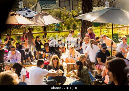 Johannesburg, South Africa - May 24, 2015: Crowds of diverse people sitting in the beer garden at outdoor farmer's market Stock Photo