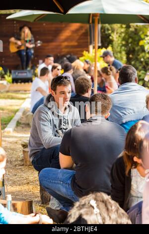 Johannesburg, South Africa - May 24, 2015: Crowds of diverse people sitting in the beer garden at outdoor farmer's market Stock Photo