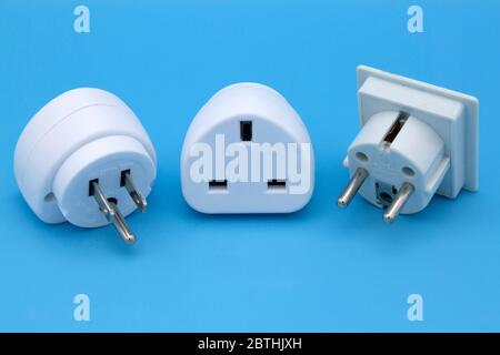 Travel adapters used for accessing electricity during international travel. The adapters enable accessories to charge from wall sockets. Stock Photo