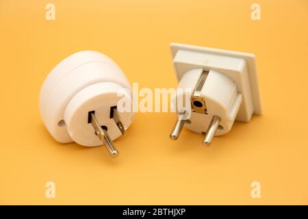 Travel adapters used for accessing electricity during international travel. The adapters enable accessories to charge from wall sockets. Stock Photo