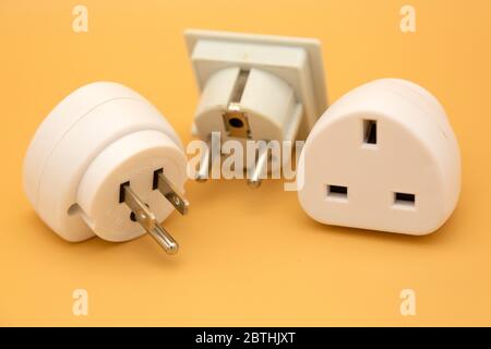 Travel adapters used for accessing electricity during international travel. The adapters enable accessories to charge from wall sockets. Stock Photo