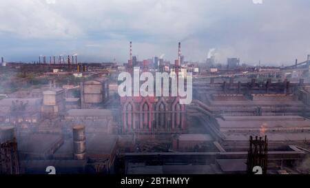 Air pollution from smoke stacks at oil refinery. chemical pipe factory smoke.  Stock Photo