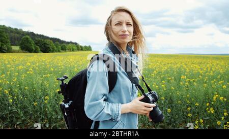Photographer looking around, side view Stock Photo