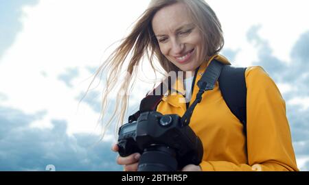 Woman looking pictures on camera Stock Photo