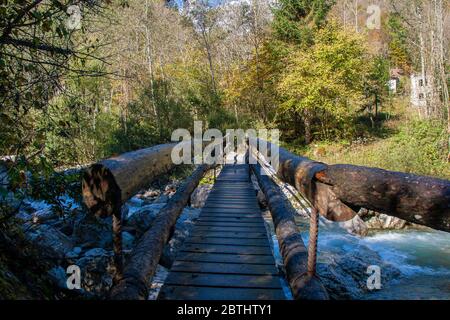Bridge over the mountain stream Stock Photo