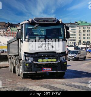Renault Trucks C of Sorakeisari Oy pulls gravel trailer in city traffic, Renault Master van in the background. Helsinki, Finland. May 26, 2020. Stock Photo