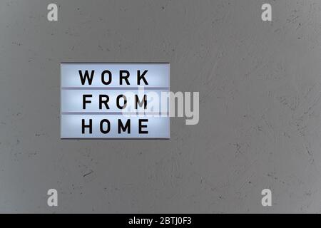 Lightbox with word work from home on wood background Stock Photo