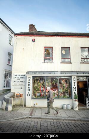 A passer by at Narberth Antiques in Pembrokeshire, Wales UK Stock Photo