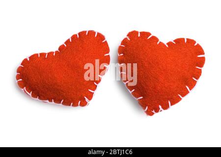 Two red handmade felt hearts  isolated on a white background. Stock Photo