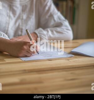 A High School Student Studies at a Table at Home Stock Photo