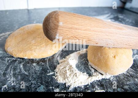 Prepare home made dough with flour and eggs and a rolling pin for pizza or pasta or bread Stock Photo