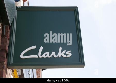 The Clarks shoe shop logo hanging from a shop in the UK