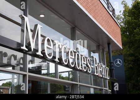 The Mercedes Benz logo at a car showroom in the UK Stock Photo