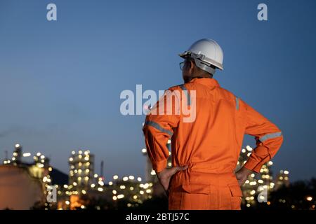 Engineer and blur refinery oil background. Stock Photo