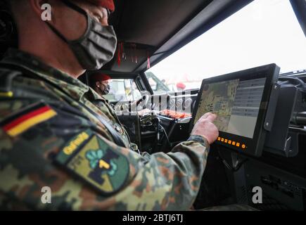 26 May 2020, Saxony, Frankenberg: Staff Sergeant Swen Plath (followed by Corporal Marcus Müller as driver) uses the Battle Management System in a Mowag Eagle 4 during the rollout presentation. The system has been introduced in the force base since the beginning of April 2020 and in the army since 11 May 2020. The system forms the backbone of the Bundeswehr's digitalization and enables the deployed units to capture a complex situation picture on the screens in the vehicles. All information on the situation of the own and enemy forces is merged and digitally evaluated and displayed to the partic Stock Photo