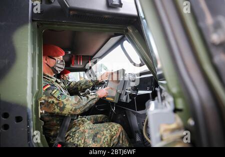26 May 2020, Saxony, Frankenberg: Staff Sergeant Swen Plath (followed by Corporal Marcus Müller as driver) uses the Battle Management System in a Mowag Eagle 4 during the rollout presentation. The system has been introduced in the force base since the beginning of April 2020 and in the army since 11 May 2020. The system forms the backbone of the Bundeswehr's digitalization and enables the deployed units to capture a complex situation picture on the screens in the vehicles. All information on the situation of the own and enemy forces is merged and digitally evaluated and displayed to the partic Stock Photo