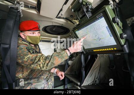 26 May 2020, Saxony, Frankenberg: During the presentation of the rollout, staff sergeant Tom Wernicke uses the Battle Management System in a Bundeswehr Fuchs/Fox transport tank. The system has been introduced in the Armed Forces Base since the beginning of April 2020 and in the Army since May 11, 2020. It forms the backbone of the Bundeswehr's digitalization and enables the deployed units to capture a complex situation picture on the screens in the vehicles. All information on the situation of the own and enemy forces is merged and digitally evaluated and displayed to the participating units. Stock Photo