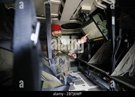 26 May 2020, Saxony, Frankenberg: During the presentation of the rollout, staff sergeant Tom Wernicke uses the Battle Management System in a Bundeswehr Fuchs/Fox transport tank. The system has been introduced in the Armed Forces Base since the beginning of April 2020 and in the Army since May 11, 2020. It forms the backbone of the Bundeswehr's digitalization and enables the deployed units to capture a complex situation picture on the screens in the vehicles. All information on the situation of the own and enemy forces is merged and digitally evaluated and displayed to the participating units. Stock Photo