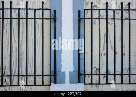 Close up of two Windows with black iron bars UK Stock Photo