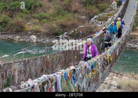 Bhutan, Punakha. Punakha Suspension Bridge, draped in prayer flags, spanning the Tsang Chhu aka Po Chhu river. Longest suspension bridge in Bhutan. Stock Photo