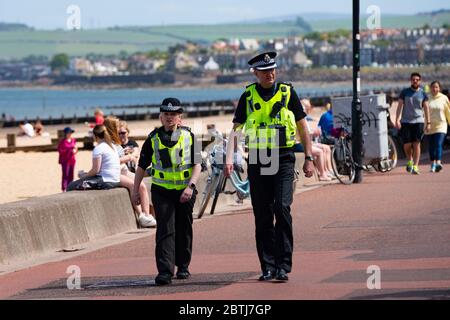 Portobello, Scotland, UK. 26 May 2020. Portobello beach and promenade were relatively quiet despite sunny warm weather. Police patrols on foot were low key and officers were not asking many members of the public to move on.  Iain Masterton/Alamy Live News Stock Photo