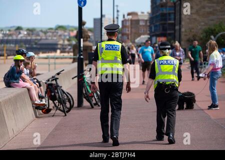 Portobello, Scotland, UK. 26 May 2020. Portobello beach and promenade were relatively quiet despite sunny warm weather. Police patrols on foot were low key and officers were not asking many members of the public to move on.  Iain Masterton/Alamy Live News Stock Photo