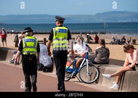 Portobello, Scotland, UK. 26 May 2020. Portobello beach and promenade were relatively quiet despite sunny warm weather. Police patrols on foot were low key and officers were not asking many members of the public to move on.  Iain Masterton/Alamy Live News Stock Photo