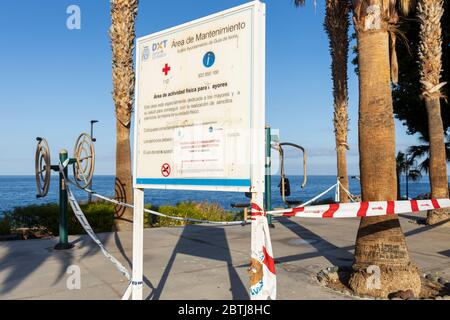 Exercise machines outdoors, taped off, closed with notice warning of fines for their use during phase two of the de-escalation of the state of emergen Stock Photo