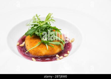 Deep fried crispy camembert cheese on the Trans-Siberian Railway, topped with a raspberry jam. Stock Photo