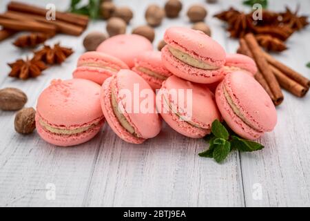 Parisian macarons, pink macaroon on a white wooden table Stock Photo