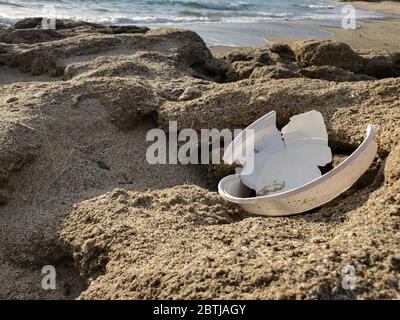 Plastic dish discarded waste on sea plants ecosystem,ocean trash contaminated habitat Stock Photo