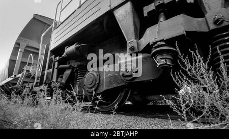 Black and white image of big cargo train cars on industrial railroad Stock Photo
