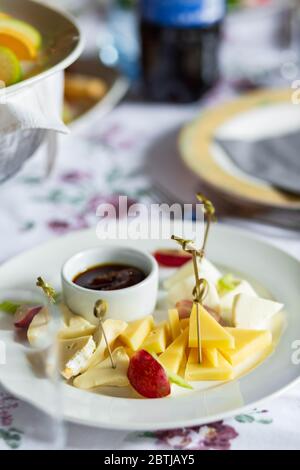 Cheese plates served with grapes, jam with oter dishes Stock Photo