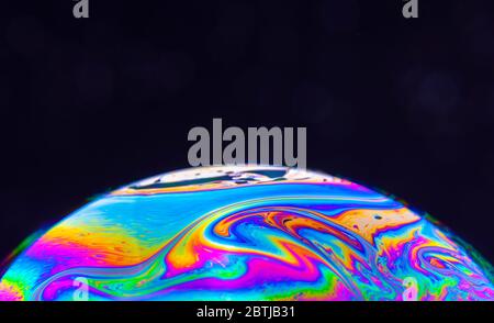 Close-up Kaleidoscope of Swirling colourful bubbles photographed in studio with a black background Stock Photo