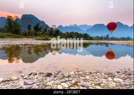 Hot Air Balloon over the Nam Song River at Sunset, Vang Vieng, Laos, Southeast Asia Stock Photo