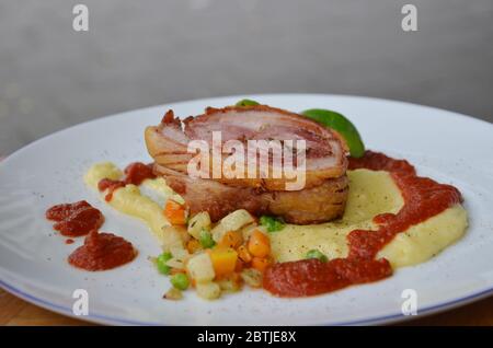 Traditional Holland style Roll pork belly with mashed potatoes and mixed vegetables. Stock Photo