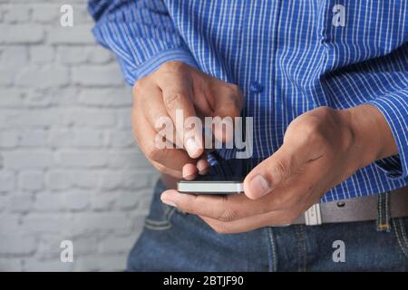 man in casual dress using mobile smart phone. Stock Photo
