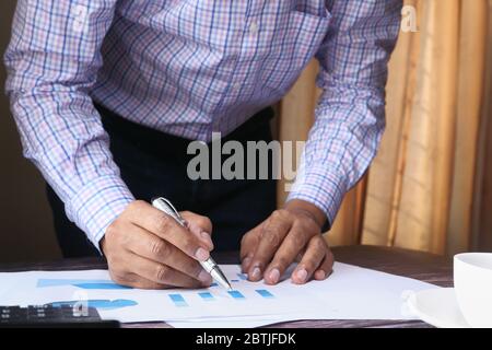businessman analyzing financial data at office desk  Stock Photo