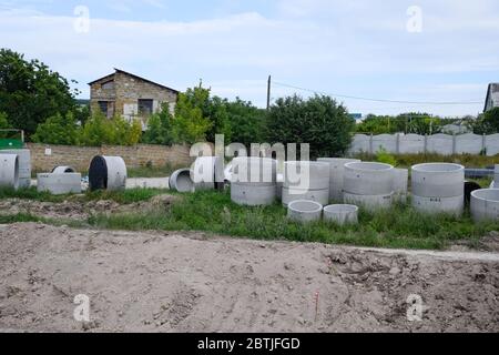 Iron concrete rings. Construction of a sewerage system. Stock Photo