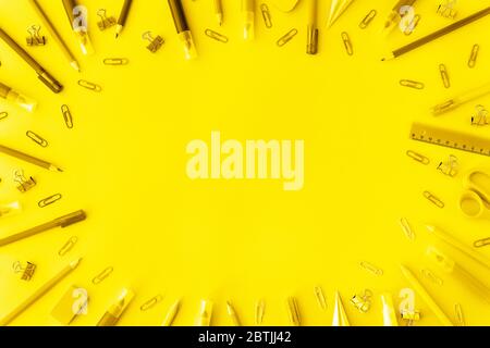 School supplies background in trendy vibrant yellow color. Back to school concept. Flat lay. Top view. Backdrop for your design. Place for text. Stock Photo