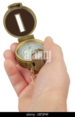 The hand holds a magnetic compass on a white background. Stock Photo