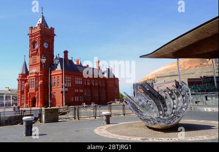 The Pierhead Building, Senedd (Welsh Assembly) Government Building and Merchant Seaman's war memorial, Cardiff Bay, Cardiff, Wales, UK. Stock Photo