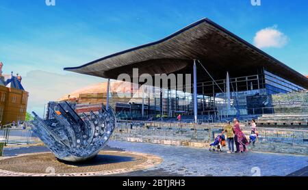The Senedd (Welsh Assembly) Government Building, Pierhead Building and Merchant Seaman's war memorial, Cardiff Bay, Cardiff, Wales, UK. Stock Photo