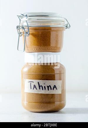 homemade sesame seed tahini spread sauce in a sealed jar on the table Stock Photo