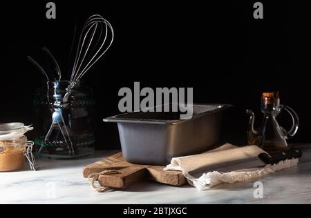 a baking tray for baking bread on the kitchen table, dark background Stock Photo
