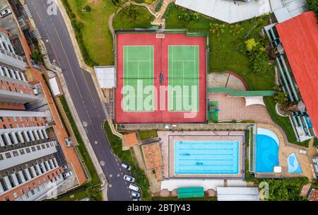An aerial top down view of a vacation club showing tennis courts, swimming pools among another places. Stock Photo