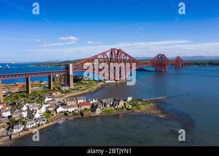 Aerial view of Forth Bridge crossing the River Forth and village of North Queensferry, Fife, Scotland, UK
