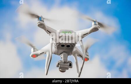 A bottom up view of a drone taking off with its propellers at maximum speed Stock Photo