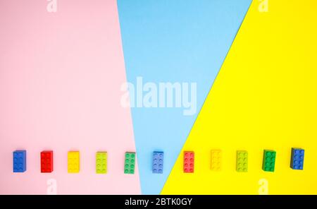 Colorful toys for kids on blue yellow background Stock Photo