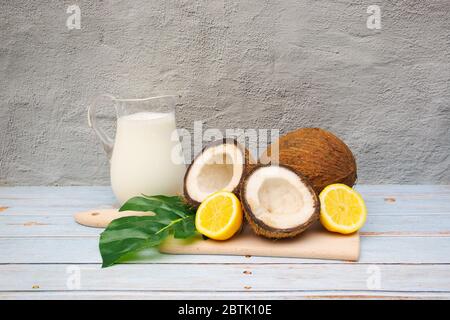 Coconuts and lemons on the table with coconut milk Stock Photo